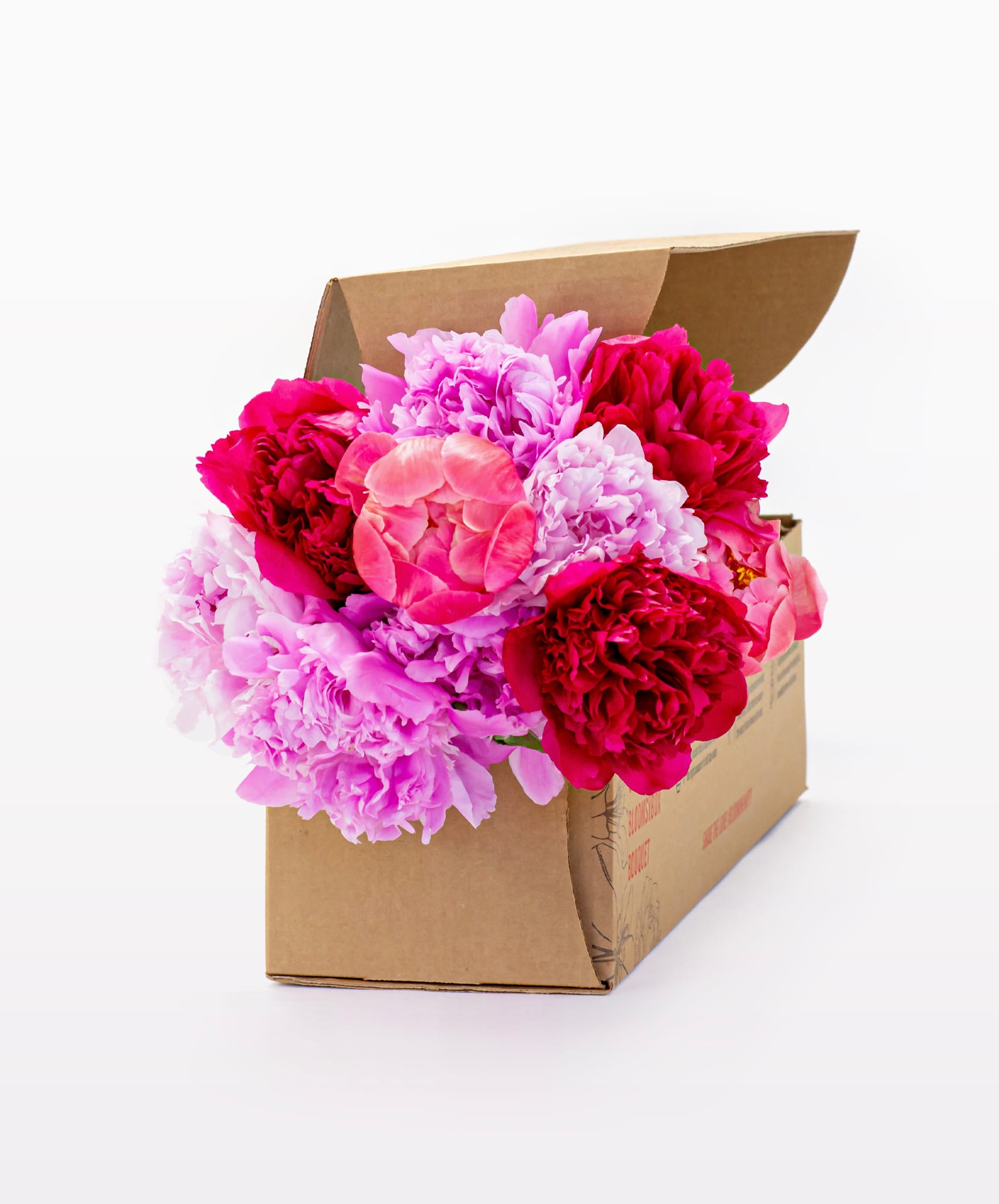 Vibrant peony bouquet in shades of pink and red, elegantly arranged in a floral gift box.